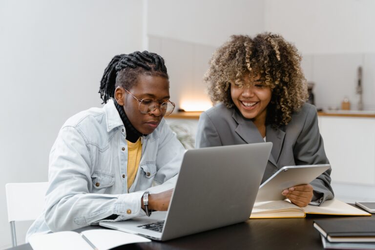 Two professionals reviewing documents at a desk