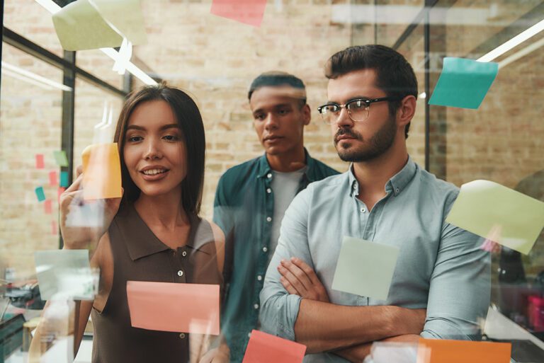 Team collaborating at a sticky-note wall